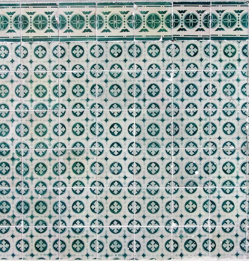 Repeating teal and cream mosaic tile pattern with geometric compass flowers and ornamental details