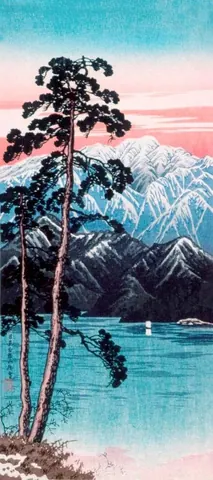 Silhouetted pine tree beside turquoise lake with snow-capped mountains at sunset in pink and blue tones.