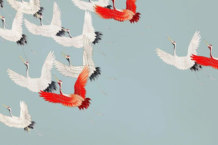 Flying cranes with red and black wing details on soft blue-grey background, repeating pattern.