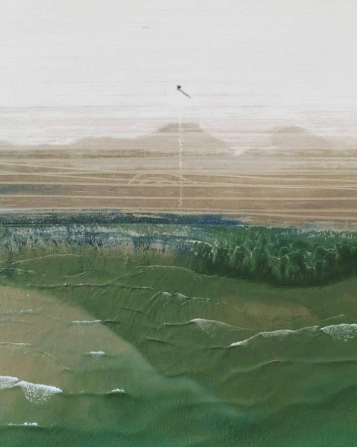 Painted landscape mural featuring misty mountains, green forested valleys, and distant peaks under soft sky.