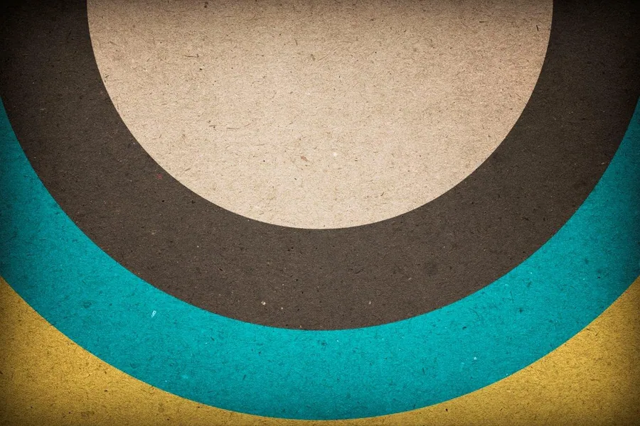 Layered semicircular arcs in cream, charcoal, teal, and mustard with textured finish