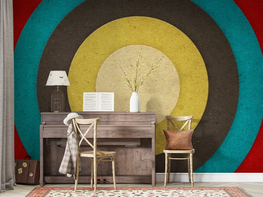 Retro concentric circles mural in yellow, teal, and charcoal with mid-century desk setup
