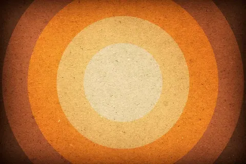 Concentric circles in cream and orange tones with textured, vintage finish