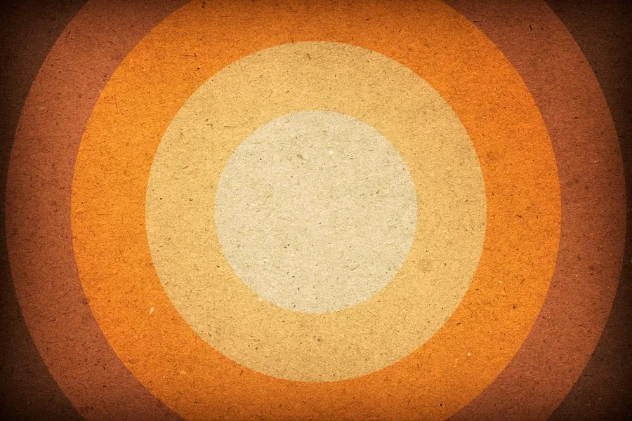 Concentric circles in cream and orange tones with textured, vintage finish