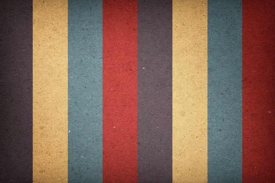 Repeating vertical stripes in gold, teal, red, and dark gray with textured finish.
