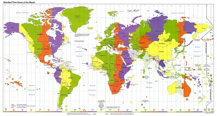 Colorful world map showing standard time zones in purple, green, orange, and yellow