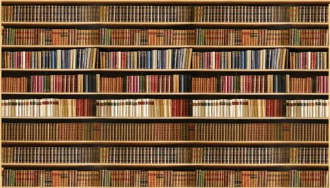 Eight shelves of stacked books in varying warm tones including gold, brown, red, and green leather spines.