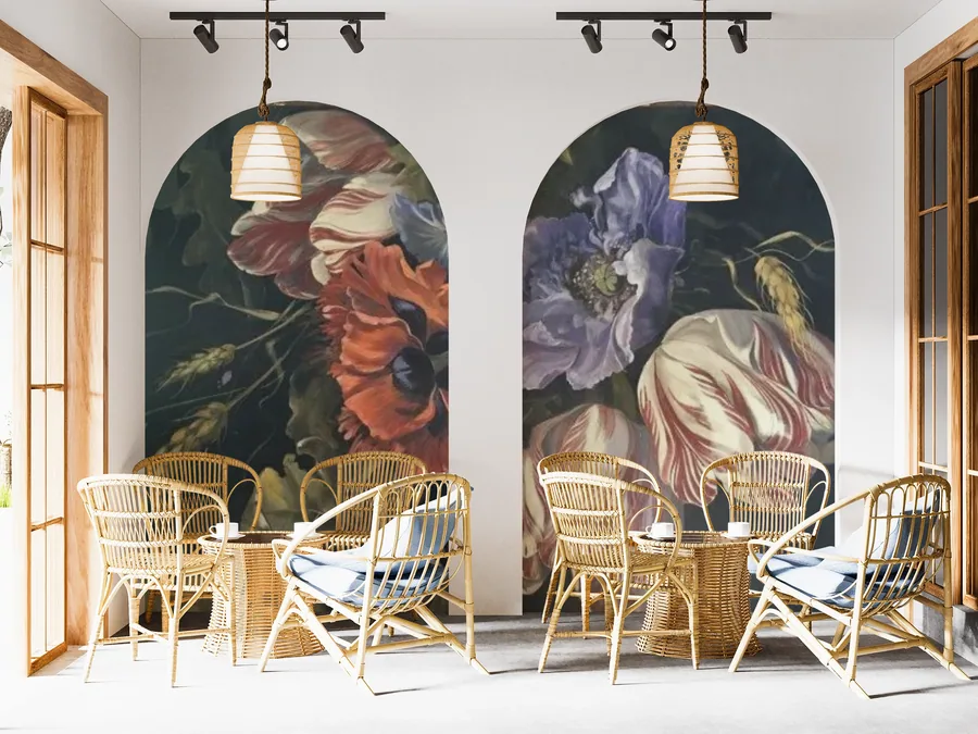 Dark botanical mural with red and purple flowers, hanging pendant lights, and wicker chairs in modern interior.