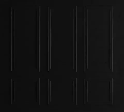 Repeating pattern of dark charcoal bevelled door panels arranged in a 3x2 grid on black background
