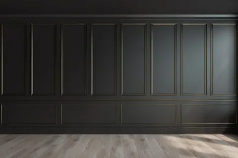 Dark charcoal wall panelling with bronze-trimmed rectangular frames and light wood flooring