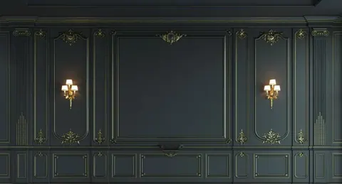 Dark green classical wall panelling with gold decorative mouldings and lit brass wall sconces.
