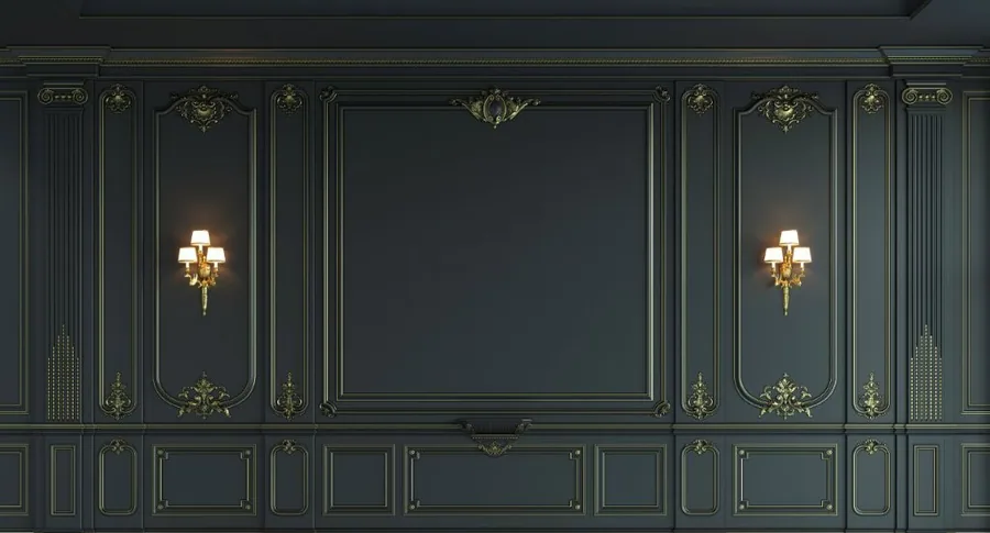 Dark green classical wall panelling with gold decorative mouldings and lit brass wall sconces.