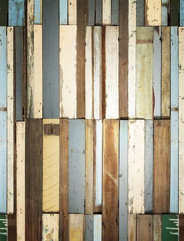 Distressed wooden planks in random block pattern with cream, grey, and brown tones