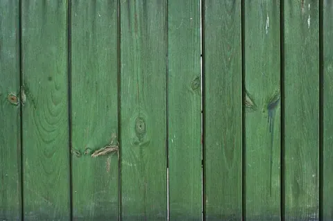 Vertical green wooden planks with natural grain texture and knots