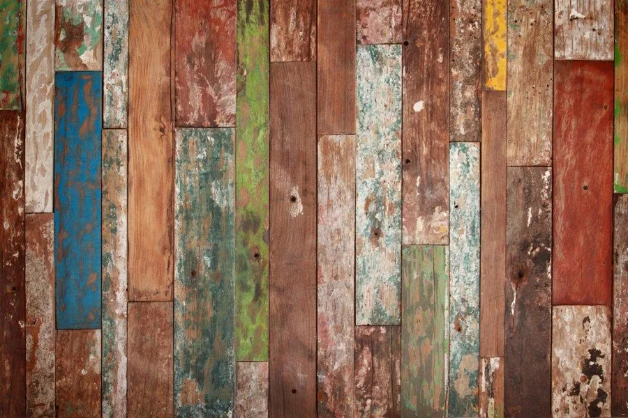 Distressed wooden floorboards with weathered paint in blue, red, green, and natural wood tones